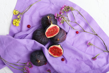 Fresh ripe figs on color napkin