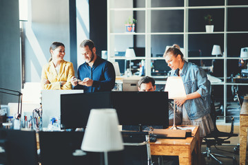 Startup and millenial business concept. Team works together in big open space office