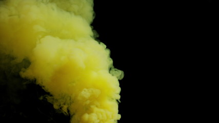 yellow bomb smoke on black background