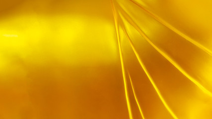 Close up beautiful glitter textured and pattern of yellow robe from shiny golden buddha sculpture...