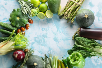 Frame made of various fresh vegetables on color background