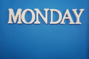 Monday alphabet letters with space copy on blue background