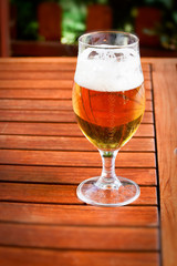 glass of beer on wooden table