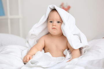 Fototapeta na wymiar Cute little baby with soft towel at home