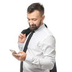 Smiling businessman with mobile phone on white background