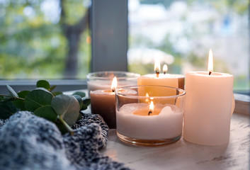 Beautiful burning candles on wooden table