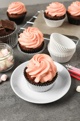 Sweet cupcakes on grey table