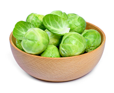 Delicious brussel sprouts in a wooden bowl. Brussel sprout, isolated on white background.