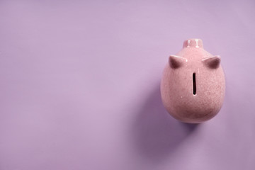 Cute piggy bank on color background