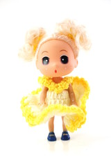 beautiful baby doll with yellow dress isolated on white background