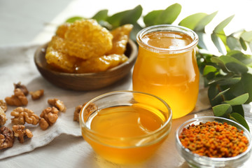 Bowl and jar with honey on table