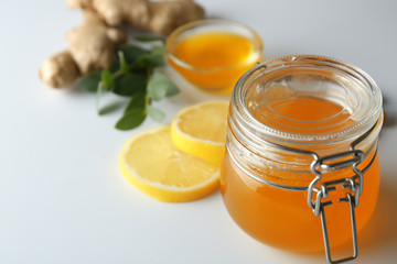 Jar with honey on light background, closeup