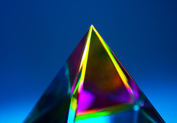 Refractions of light in a glass prism. Focus is on tip