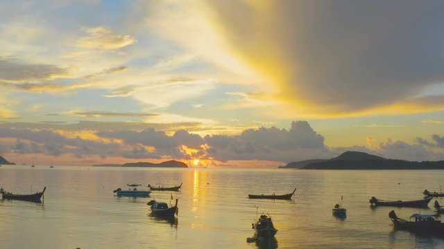 ishing boat in sunrise in Rawai beach.