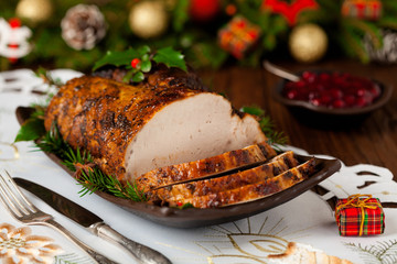 Roast pork loin with Christmas decoration.