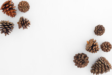 Christmas pine cones on white paper border composition. Creative flat lay, top view design