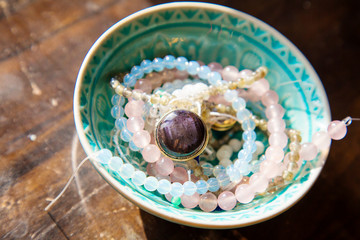 Natural mineral stone beads in decorative bowl