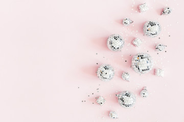 Christmas composition. Silver disco balls on pastel pink background. Christmas, winter, new year...