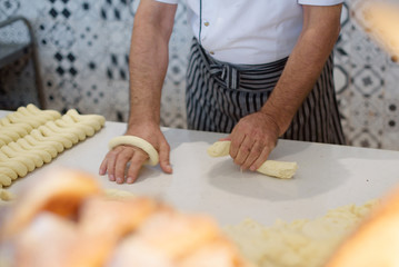 a man cooking turkish bagels (simit)