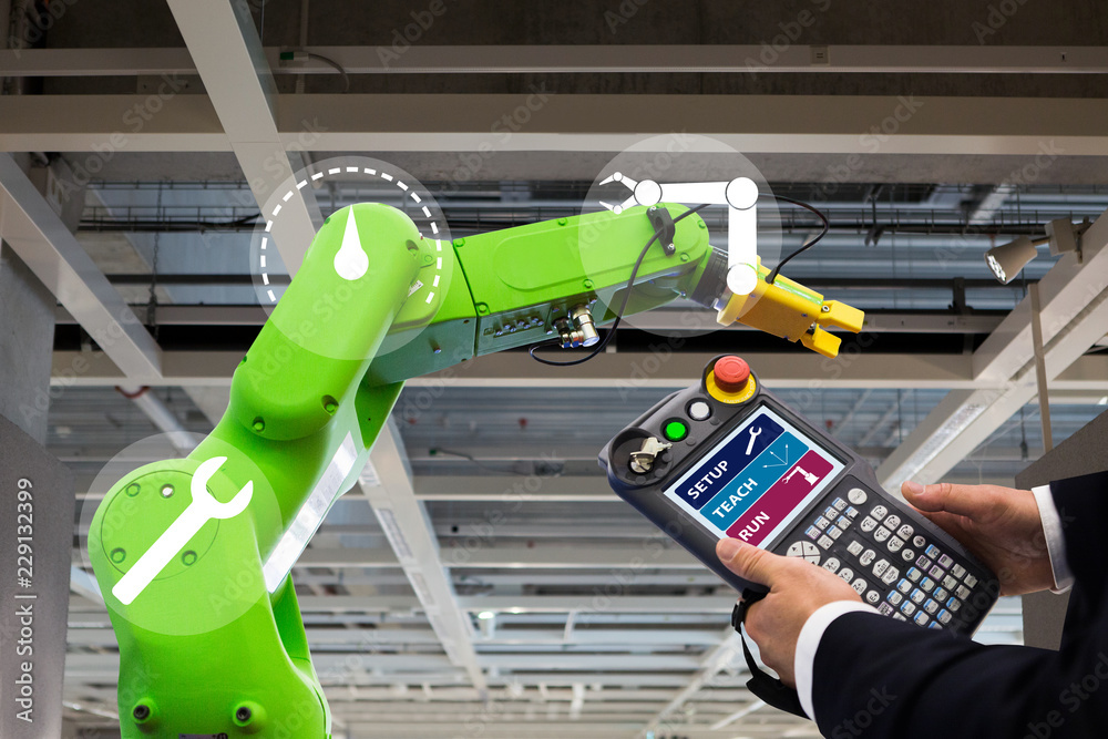 Aufkleber Engineer with teach pendant device. Programming robot with robotic arm. Smart factory 