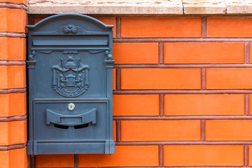 A beautiful mailbox hangs waiting for newspapers, parcels and letters.