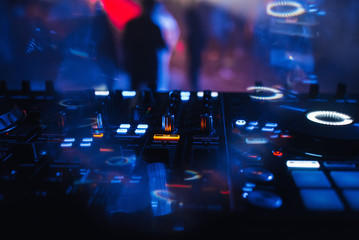 DJ mixer for mixing music and sound in a nightclub at a party