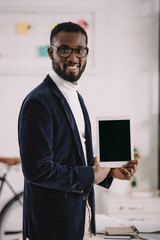 successful african american businessman presenting digital tablet with blank screen