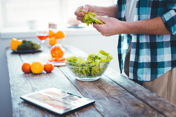 Green salad. Close up of a bowl with green lettuce standing on the kitchen table