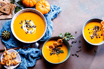 Roasted pumpkin and carrot soup with cream and pumpkin seeds 