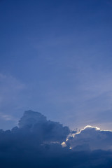 Beautiful clouds in the blue sky and the sun is hiding behind the clouds.