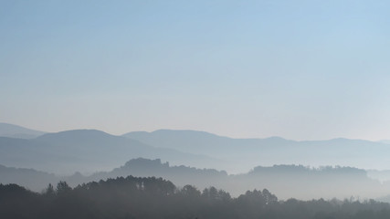 Wooded Lunigiana hills, north Tuscany, Italy. Beautiful misty early morning, calm landscape.
