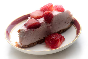 slice of strawberry cheesecake on white background, selective focus