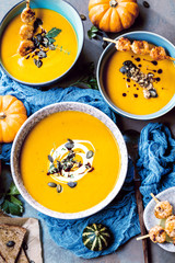 Roasted pumpkin and carrot soup with cream and pumpkin seeds 