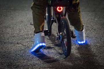 feet in shining shoes on the bike.