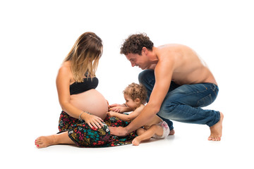 Pregnant woman with her little girl and her husband on isolated white background
