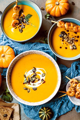 Roasted pumpkin and carrot soup with cream and pumpkin seeds 