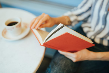 Closeup of a woman reading a book - obrazy, fototapety, plakaty