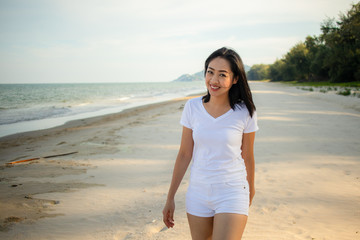 Happy woman go for a walk on the beach.