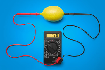 Measurement of electric tension in lemon. Blue background