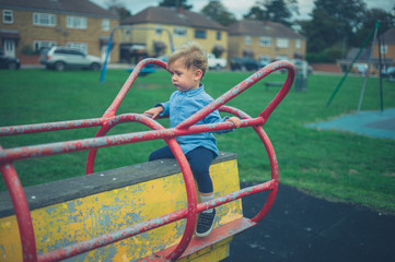 Toddler on play equipment in the park