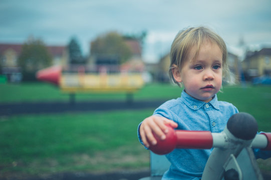Toddler on play equipment in the park