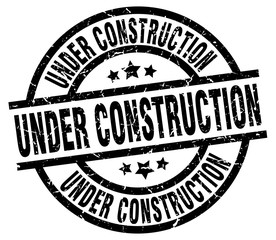 under construction round grunge black stamp