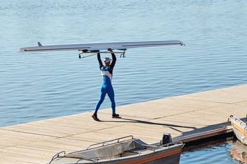 Young athlete guy carries a kayak. © SKfoto