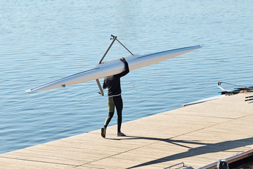 Young athlete guy carries a kayak. © SKfoto