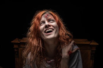 Scary woman possessed by devil in the bed. Exorcism of priest.