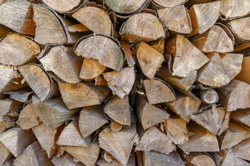 A pile of stacked firewood. Firewood harvested for heating in winter. Chopped firewood on a stack.
