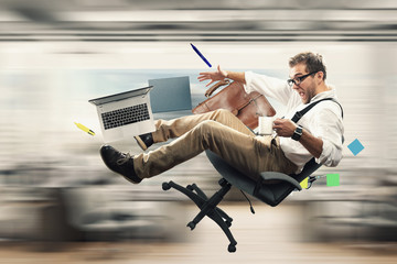 Young male employee falling from the chair