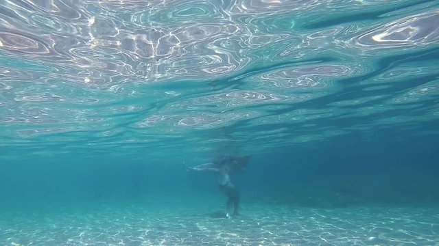 girls in thong play underwater