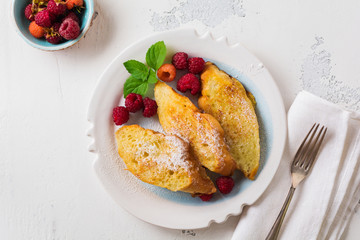 French sweet toasts with berries. Old gray vintage background. Top view. Copy space.