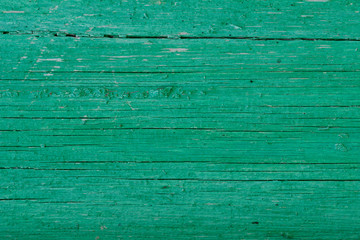 Fototapeta premium The old board is painted green with cracks.
